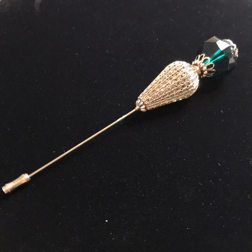 Costume jewelry stick pin.